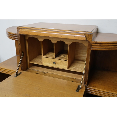 129 - An early 20th century Art Deco cabinet bookcase with central fall front compartment over pair of cab... 