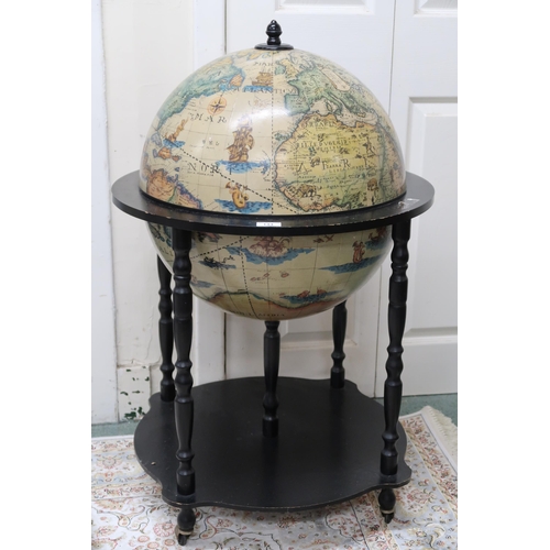 144 - A 20th century reproduction drinks globe on shaped base terminating in casters, 94cm high x 60cm dia... 