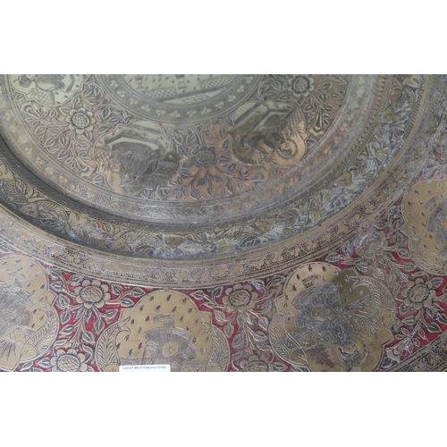 20 - A 20th century Moorish style circular brass topped table on folding base with masharabiya panel... 