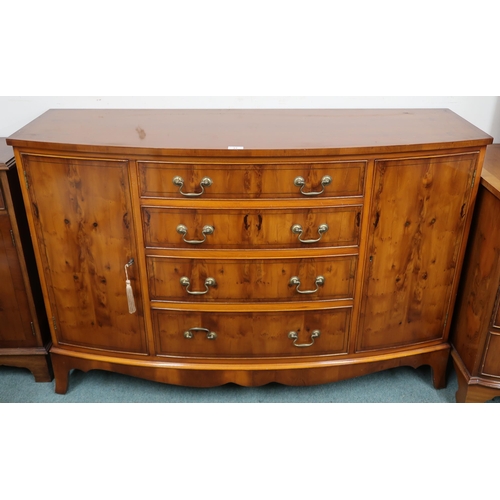 33 - A 20th century reproduction dining suite comprising bowfront sideboard with four central drawers fla... 