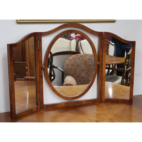 35 - A 20th century reproduction serpentine front dressing table with triple plate dressing mirror over c... 