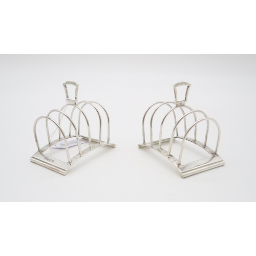 354 - A pair of four division silver toast racks, by Edward & Sons, Birmingham 1938, in the Art Deco s... 