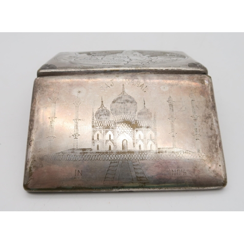 375 - An Indian white metal cigarette case, engraved with the Taj Mahal, the reverse with a map, with flow... 