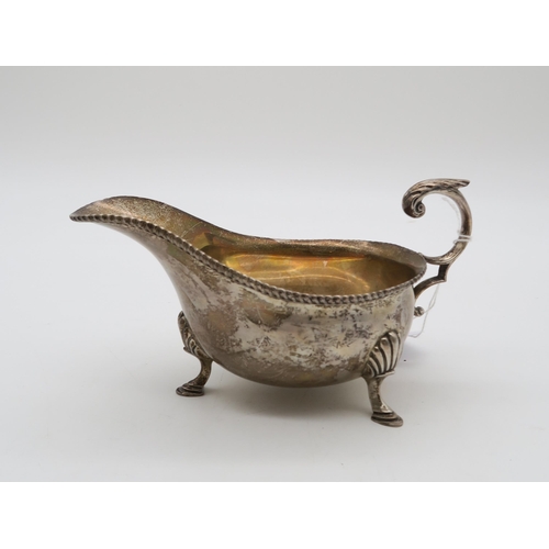 377 - A silver sauce boat, by Harrison Brothers & Howson, London 1931, in the George III style, with a... 