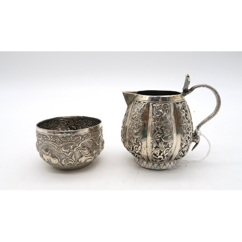 387 - An Indian Kutch silver cream jug, with a cobra handle, and an Indian silver sugar bowl, 157gms (2)