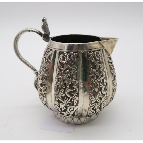 387 - An Indian Kutch silver cream jug, with a cobra handle, and an Indian silver sugar bowl, 157gms (2)