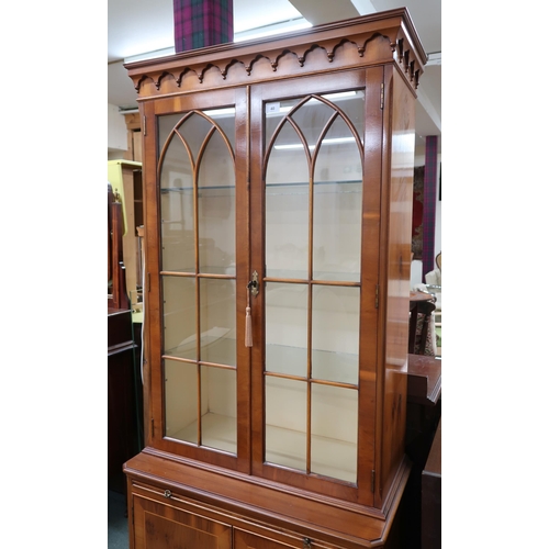 40 - A 20th century reproduction bookcase with moulded cornice over pair of glazed doors on base with wri... 