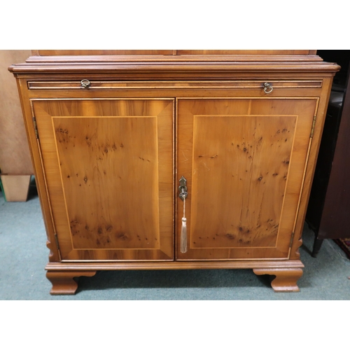 40 - A 20th century reproduction bookcase with moulded cornice over pair of glazed doors on base with wri... 