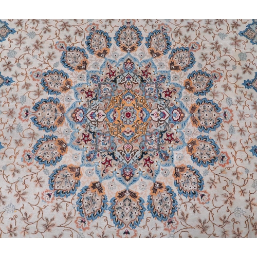 53 - A beige floral patterned ground Tabriz rug with multicoloured central medallion and matching borders... 