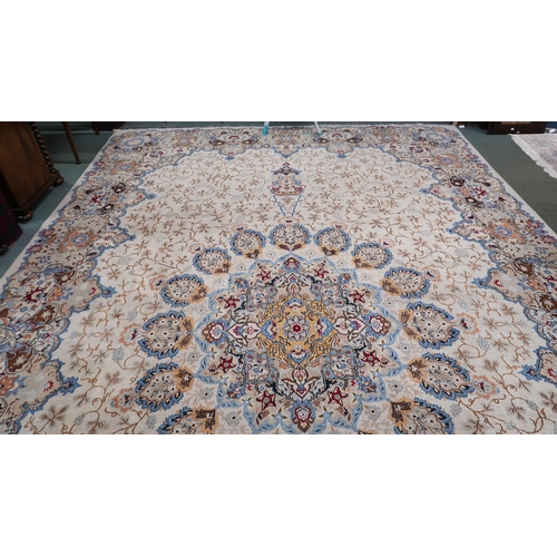 53 - A beige floral patterned ground Tabriz rug with multicoloured central medallion and matching borders... 