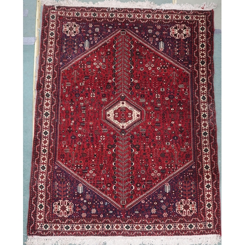 78 - A red ground Balouch rug with cream geometric central medallion, dark blue spandrels and cream borde... 