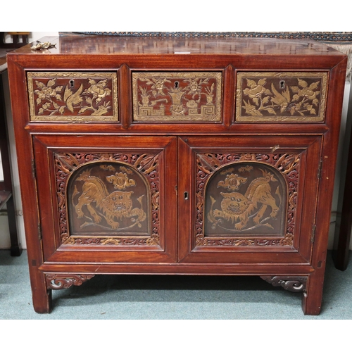 8 - An early 20th century Chinese side cabinet with three short drawers carved with birds and floral mot... 