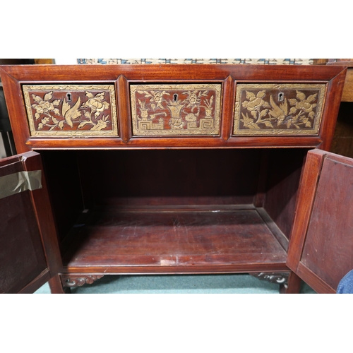 8 - An early 20th century Chinese side cabinet with three short drawers carved with birds and floral mot... 