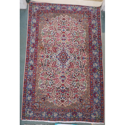 80 - A cream floral pattern ground Keshan rug with light blue central medallion, blue spandrels and light... 