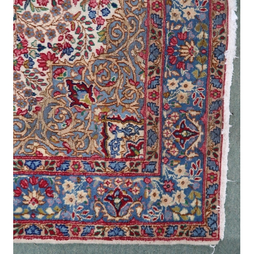 80 - A cream floral pattern ground Keshan rug with light blue central medallion, blue spandrels and light... 