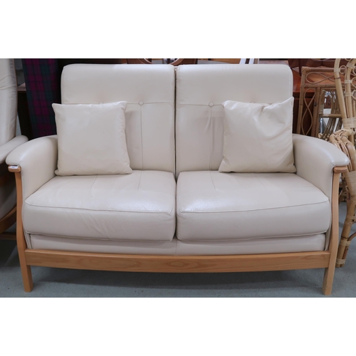 82 - A contemporary elm and beech framed Ercol Gina two seater sofa with cream leather upholstery, 94cm h... 