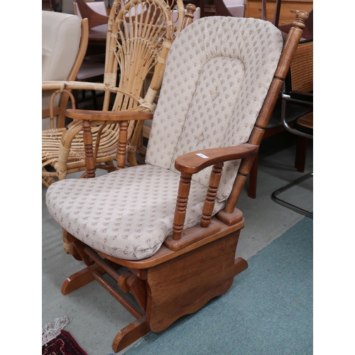 83 - A contemporary beech framed rocking chair with cream upholstered cushions, 103cm high x 70cm wide x ... 