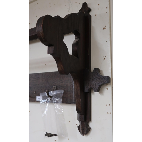 90 - A 20th century oak wall mounted coat rack, 57cm high x 122cm wide x 28cm deep