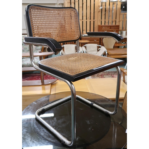 93 - A lot comprising three Marcel Breuer style cantilever chairs with ebonised cane backs and seats and ... 