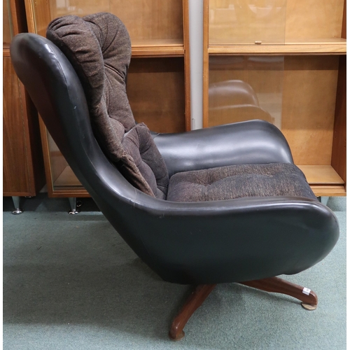 94 - A mid 20th century black vinyl upholstered revolving chair in the manner of Arne Jacobsen, 93cm high... 