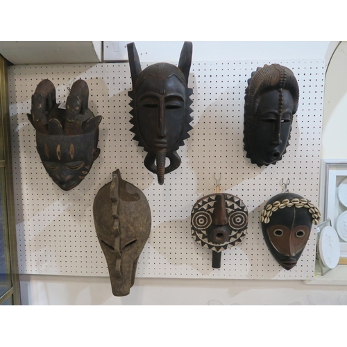 202 - A collection of African tribal masks and example from Papa New Guinea