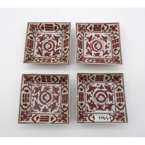 258 - A set of four Chinese iron red 'crane and trigram' square dishes, apocryphal jiajing mark (4)