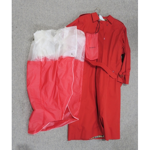 265 - A red Burberry ladies raincoatName: 12 long C87AOrder: E58601/1together with a Mary Quant red and cl... 