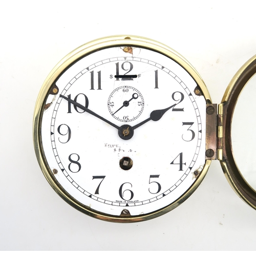 444 - A brass ship's bulkhead clock by Kelvin, Bottomley & Baird, Glasgow, the white enamelled dial wi... 