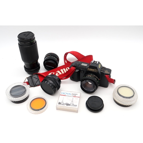 458 - A Canon T70 camera, fitted with a Canon FD 50mm 1:18 lens, with three alternate lenses (Makinon MC Z... 