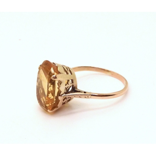 611 - A yellow metal mounted citrine ring, finger size W1/2, weight 4.5gms