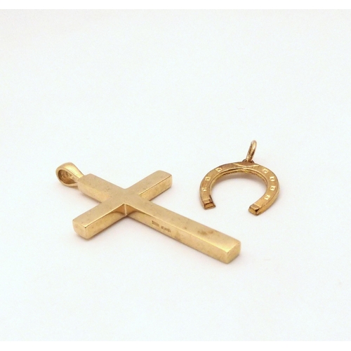 635 - A solid 9ct gold cross 5.2cm x 2.7cm, together with a 9ct gold horseshoe pendant, weight together 11... 