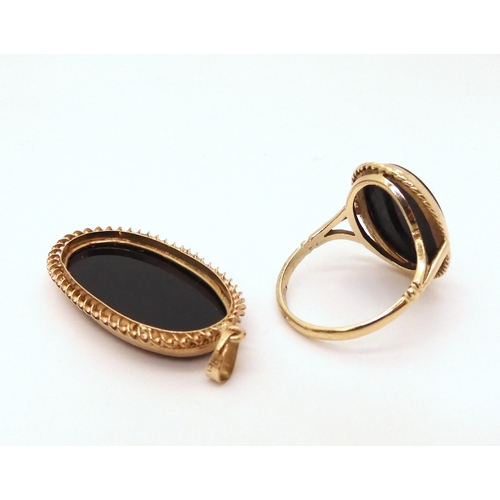 638 - A 9ct gold onyx ring, size Q, together with a similar pendant, weight together 7.5gms