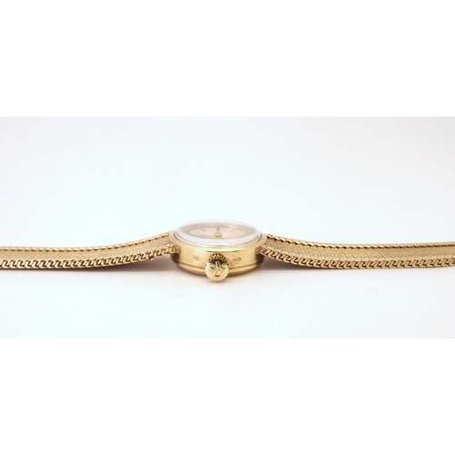 644 - A 9ct gold ladies Record De Luxe wristwatch with integral strap, weight including mechanism 21.5gms