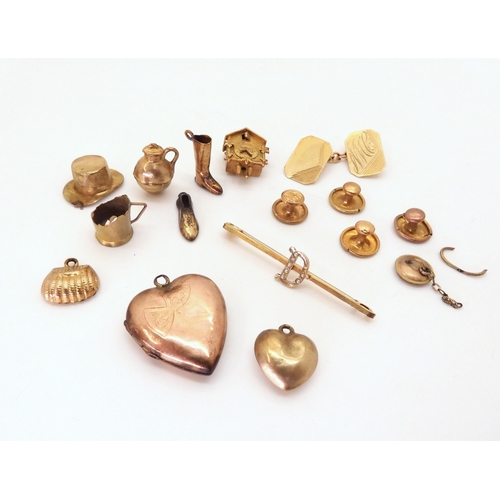 684 - A collection of 9ct gold and yellow metal charms to include a Cuckoo clock, a cufflink and three stu... 