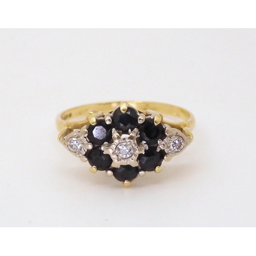 704 - An 18ct gold sapphire and diamond flower cluster ring, diamond content estimated approx 0.10cts, siz... 