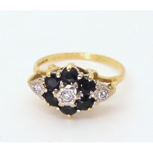 704 - An 18ct gold sapphire and diamond flower cluster ring, diamond content estimated approx 0.10cts, siz... 