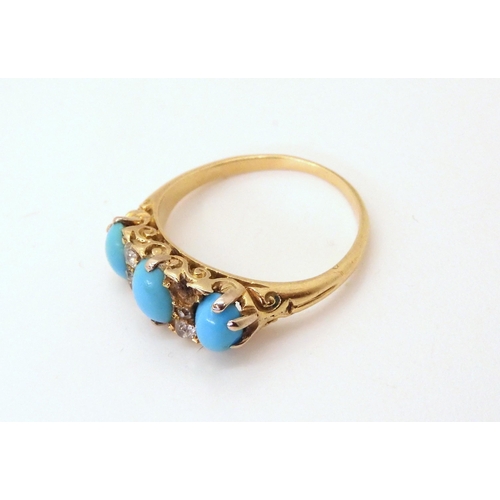 716 - An 18ct gold turquoise three stone with old cut diamond accents in classic scroll mount (one diamond... 