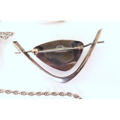 736 - A silver Scandinavian tigers eye brooch stamped WWL, a white metal guard chain with Marine style lin... 