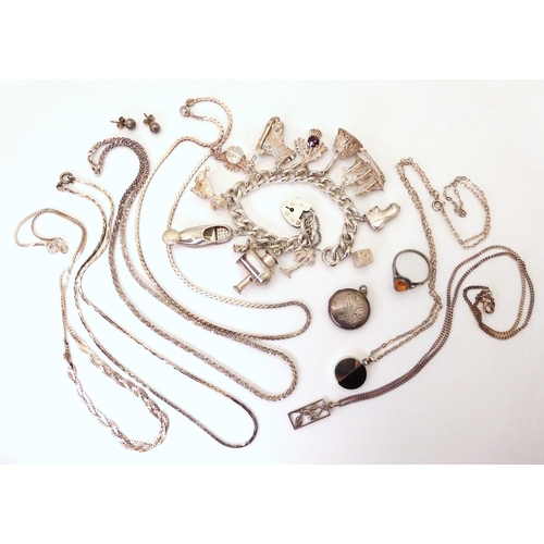 751 - A silver charm bracelet with twelve large charms, and a collection of silver charms