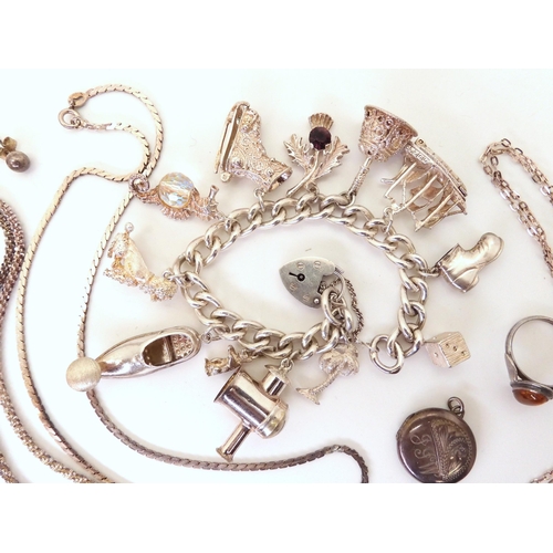 751 - A silver charm bracelet with twelve large charms, and a collection of silver charms