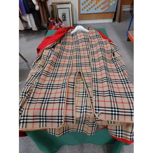 265 - A red Burberry ladies raincoatName: 12 long C87AOrder: E58601/1together with a Mary Quant red and cl... 