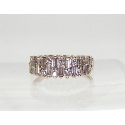 2724 - AN 18CT ETERNITY RINGAn 18ct white gold baguette and brilliant cut half eternity ring, set with esti... 