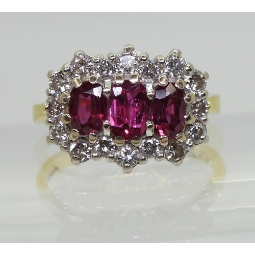 2738 - A RUBY AND DIAMOND RING18ct gold set with three rubies, largest approx. 6mm x 3.7mm x 2.6mm, smaller... 