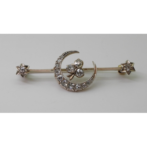 2766 - A DIAMOND CRESCENT MOON BROOCHthe white metal mount is set with estimated approx 0.50cts of old cut ... 