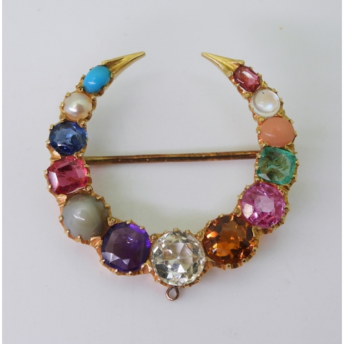 2769 - A GEM SET CRESCENT MOON BROOCHset with gem specimens to include, cats eye chrysoberyl, amethyst, sap... 