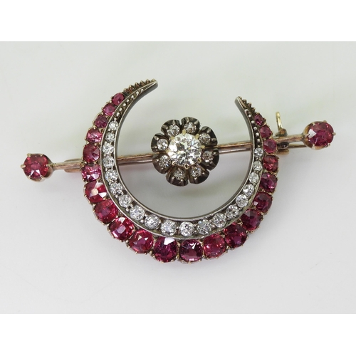 2835 - A SUBSTANTIAL CRESCENT MOON BROOCHset with diamonds and rubies to the crescent, central flower and t... 