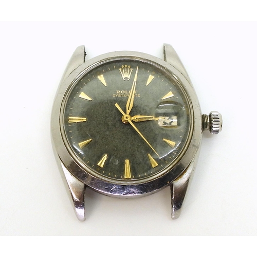 2918 - A ROLEX OYSTERDATEin stainless steel, with black dial, gold coloured chevron numeral and hands, with... 