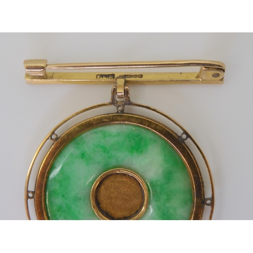 802 - A chinese green hardstone rondel brooch, the centre with Chinese symbol, in a twisted wirework 9ct g... 