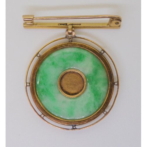 802 - A chinese green hardstone rondel brooch, the centre with Chinese symbol, in a twisted wirework 9ct g... 