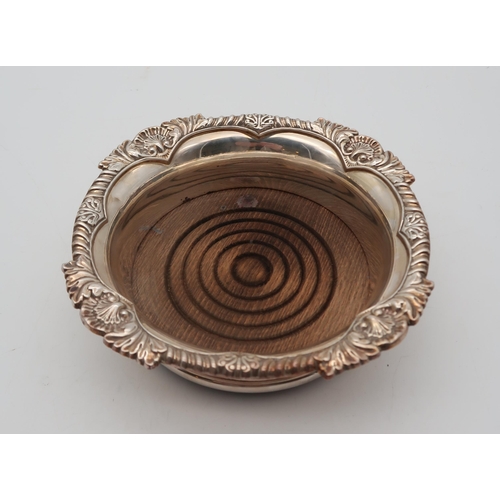 356 - An Elizabeth II silver wine coaster, by Mappin & Webb, Sheffield, with a gadrooned shell border,... 